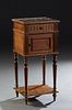 French Louis XVI Style Marble Top Nightstand, early 20th c., the inset highly figural brown marble over a frieze drawer and a pot cupboard planked by 