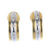 A pair of 18ct gold diamond earrings. Each of bi-colour design, the ridged half-hoop with brilliant-