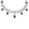 A sapphire and diamond necklace. The graduated oval-shape sapphire and brilliant-cut diamond cluster