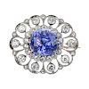 An early 20th century sapphire and diamond brooch. Of openwork design, the cushion-shape sapphire, w