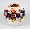 An unusual Walter Moorcroft 'Pansy' pattern vase Circa 1950, of ovoid form, with tube-lined decorati