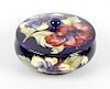 A Moorcroft Hibiscus pattern bowl and cover. Circa 1950s, the circular cover and squat cauldron-form