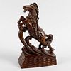 An unusual Oriental carved wooden figure. Modelled as a saddled horse galloping upon a wave, with in