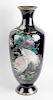 A good large Japanese Meiji period cloisonne vase. Of ovoid form with tall flared neck and footed ba
