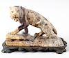 An Eastern hardstone figure of a tiger. Stood in crouched stance with open mouth upon a rocky base a