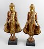 A pair of carved, painted and gilded wood figures. Each modelled as an Eastern deity, dressed in flo