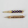 Two yellow metal retractable pencils. The first having enamelled chequered barrel and marked 'M' to