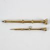 Two 19th century yellow metal propelling pencils. Each of facetted form with stone-set terminal, la