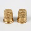Two 10K yellow metal thimbles. One initialed CMS and numbered 9, the other initialed MG, both intern