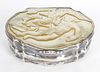 A mother-of-pearl mounted snuff box. Of organic form having low relief carved scene to the hinged co