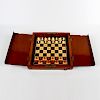 A mahogany-cased travel chess set. Early 20th century, the folding board with internal covers enclos