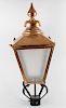 A reproduction copper lantern. The tiered spire finial over pyramidal top and tapering four sided bo