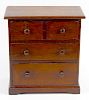 A 19th century mahogany miniature chest of drawers. Perhaps an apprentice piece, the rectangular top