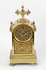 A late 19th century French brass mantel clock. The 3.75 Roman dial with rosette centre, the two trai