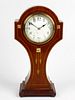 An Art Nouveau inlaid mahogany 'balloon' mantel clock. Having a 3.5-inch white Arabic dial, the Fren