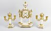 A French portico clock garniture. The white enamelled dial having Arabic numerals and floral swag de
