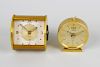 Two Jaeger travel clocks. The first with rectangular dial having gilt circular chapter with Arabic q