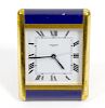 A Cartier desk clock The square white Roam dial marked CARTIER PARIS, within brass and dark blue lac