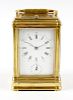 A third quarter 19th century brass gorge-cased carriage clock. Drocourt, Paris. The white enamel dia