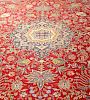 A large mid 20th century Persian carpet. The crimson field with lobed central medallion between flow