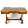 A mid 19th century inlaid satinwood library or centre table. The moulded oblong top with inverted br