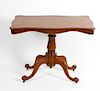 A Victorian mahogany pedestal centre table. The serpentine-sided oblong top on a bulbous stem and fo