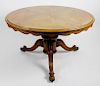 A 19th century walnut and mahogany breakfast or centre table. The walnut veneered top with moulded e