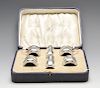 A 1920's cased silver part condiment set comprising a pair of pepper pots, a pair of open salts and