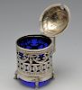 A German silver mustard pot with blue glass liner, having ribbon and garland swag piercing above geo