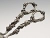 A pair of Victorian silver grape scissors, ornately decorated throughout with trailing and fruiting