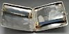 Two 1920's silver cigarette cases, the first of rounded square form with foliate scroll engraving th
