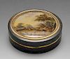 A tortoiseshell box of circular form with gold tone borders, the lid with painted panel depicting a