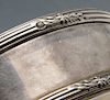 A French silver box of circular form with reeded borders and floral spray accents, the hinged cover