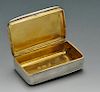 A William IV silver snuff box of rounded rectangular form with reeded sides, the hinged lid opening