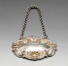 An early Victorian silver Sherry label with fruiting vine surround and suspended on belcher link cha