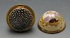 An enamel nutmeg grater of ovoid form, with gold tone mounts and gilt borders surrounding painted ru