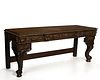 A large Continental Baroque-style carved oak side table