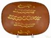 Pennsylvania redware loaf dish, 19th c., with yellow slip decoration, 9 3/4'' h., 13 1/2'' w.