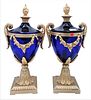 Pair of French Style Urns, cobalt blue glass with ormolu mounts, flame torch finial on acanthus square foot, height 20 1/4 inches.