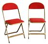 Set of Twelve Mid Century Modern Folding Chairs, having gold painted metal frames and red upholstery.