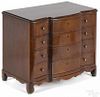 Miniature New England mahogany chest of drawers, ca. 1800, with a serpentine front