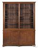 Pine two-part store display cabinet, 19th c., the upper section with two glazed sliding doors