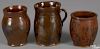 Three Pennsylvania redware apple butter crocks, 19th c., with manganese splotching on a red ground