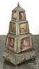Unusual tramp art carved and painted revolving pyramid portrait cabinet, ca. 1900, with two drawers