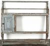 Continental painted pine hanging pewter shelf, 19th c., with a single raised panel door