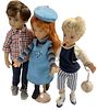 Lot of 3 dolls. First doll with checkered shirt is 13 1/2" tall and marked Maru and Friends in hard vinyl. He has blue inset eyes. Redhead doll is by 