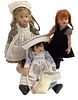 Lot of 3 Kish & Co dolls in hard vinyl and just under 8". One has a nurse vocation theme with hat and medical bag, circa 2003. Dolls are five-jointed.