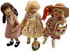 Lot of 3 Kish & Co hard vinyl dolls @ approx 7 1/2" tall. Doll in red is circa 2004, has jointed knees and has a purse (some glue residue shown on bag