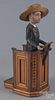 Carved and painted figure of a preacher, early 20th c., standing at a lectern, overall - 21'' h.