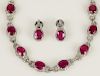 Lady's 21 Large Oval Brilliant Cut Ruby and 14 Karat White Gold Necklace and Earring Suite accented throughout with small Round Brilliant Cut Diamonds